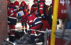 Medics provide assistance to victims of a rocket attack in a tent