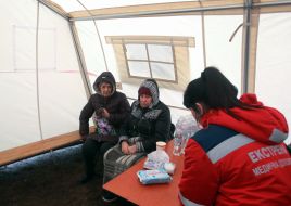 Medics provide assistance to victims of a rocket attack in a tent