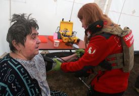 Medics provide assistance to victims of a rocket attack in a tent