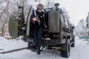 A police officer gets out of an armored car