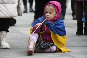 A girl with the flag of Ukraine on her shoulders