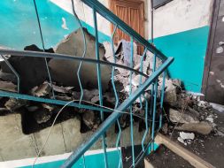 The passage to the 4th floor of a residential building is blocked by the remains of the 5th floor after a Russian missile hit in the city of Mirnograd, Donetsk region