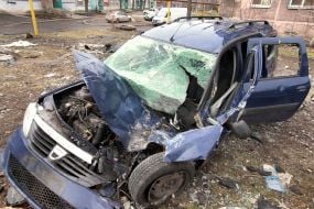 Destroyed car near a 5-story residential building destroyed by Russian rocket fire in the city of Myrnograd