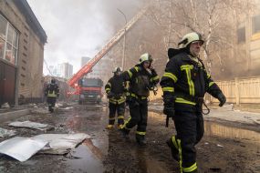 Firefighters put out a fire at the site of a Russian rocket landing in Kharkiv