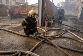 Firefighters put out a fire at the site of a Russian rocket landing in Kharkiv