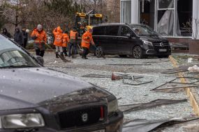 Employees of communal services remove windows broken as a result of rocket fire near a residential building in Odesa