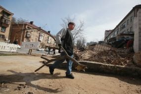 Volunteers clear away the rubble of the Academy of Decorative and Applied Arts building