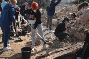 Volunteers clear away the rubble of the Academy of Decorative and Applied Arts building