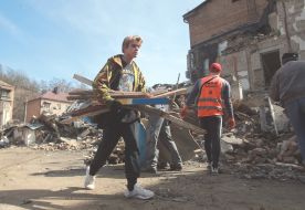Volunteers clear away the rubble of the Academy of Decorative and Applied Arts building