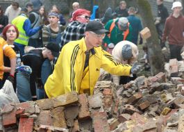 Volunteers clear away the rubble of the Academy of Decorative and Applied Arts building
