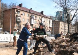 Volunteers clear away the rubble of the Academy of Decorative and Applied Arts building
