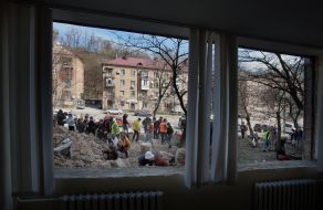 Volunteers clear away the rubble of the Academy of Decorative and Applied Arts building