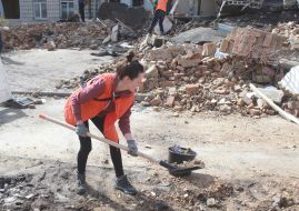 Volunteers clear away the rubble of the Academy of Decorative and Applied Arts building