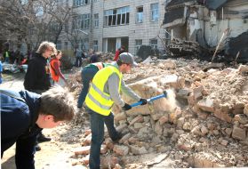 Volunteers clear away the rubble of the Academy of Decorative and Applied Arts building