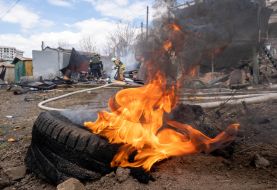 Rescue workers put out a fire caused by a missile strike in Kharkiv,