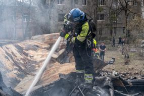 Rescue workers put out a fire caused by a missile strike in Kharkiv,