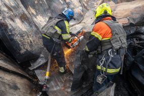 Rescue workers put out a fire caused by a missile strike in Kharkiv,