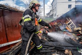 Rescue workers put out a fire caused by a missile strike in Kharkiv,