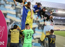 Football players of FC "Rukh" (Lviv) sign flags for fans