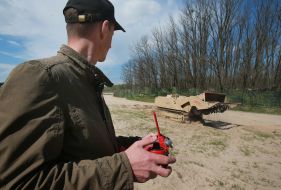 The operator controls the robotic complex for demining