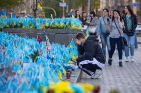 A man near the flags commemorating the fallen defenders of Ukraine