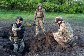 Military sappers study the place where the debris of the rocket fell in Kharkiv