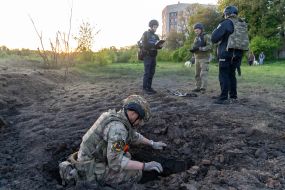 Military sappers study the place where the debris of the rocket fell in Kharkiv
