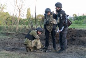 Military sappers study the place where the debris of the rocket fell in Kharkiv
