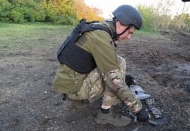 Military sappers study the place where the debris of the rocket fell in Kharkiv