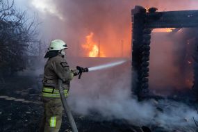 Rescuers extinguish a fire in a private house caused by a rocket attack in Kharkov