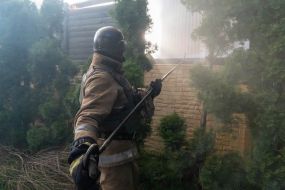 Rescuers extinguish a fire in a private house caused by a rocket attack in Kharkov