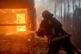 Rescuers extinguish a fire in a private house caused by a rocket attack in Kharkov