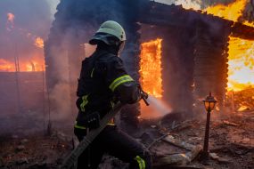 Rescuers extinguish a fire in a private house caused by a rocket attack in Kharkov
