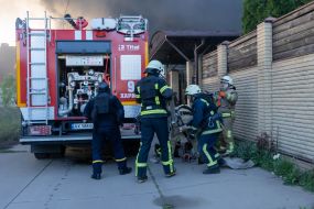 Rescuers extinguish a fire in a private house caused by a rocket attack in Kharkov