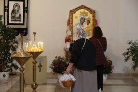 A believer with an Easter basket near an icon