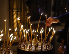 A girl lights a candle