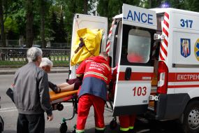 Пожилую женщину транспортируют в машину скорой помощи