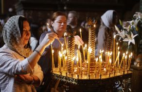 A girl lights a candle
