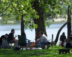 People rest on the shore of Lake Sonyachne in Kyiv