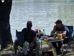 People rest on the shore of Lake Sonyachne in Kyiv