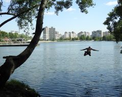 A man jumps into the water at the Sunny Lake in Kyiv