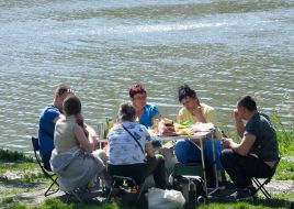 People rest on the shore of Lake Sonyachne in Kyiv