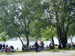 People rest on the shore of Lake Sonyachne in Kyiv