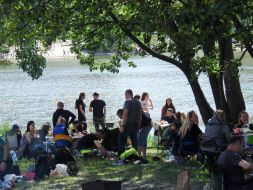 People rest on the shore of Lake Sonyachne in Kyiv