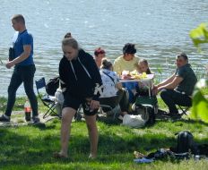 People rest on the shore of Lake Sonyachne in Kyiv