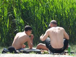 People rest on the shore of Lake Sonyachne in Kyiv