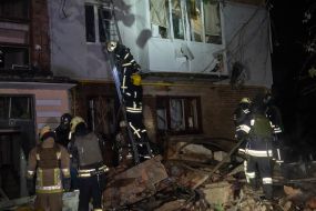 Rescuers are sorting through the rubble of an apartment building in Kharkiv that was destroyed by a Russian missile
