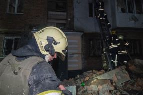 Rescuers are sorting through the rubble of an apartment building in Kharkiv that was destroyed by a Russian missile