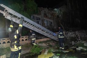 Rescuers are sorting through the rubble of an apartment building in Kharkiv that was destroyed by a Russian missile