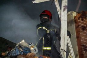 Rescuers are sorting through the rubble of an apartment building in Kharkiv that was destroyed by a Russian missile